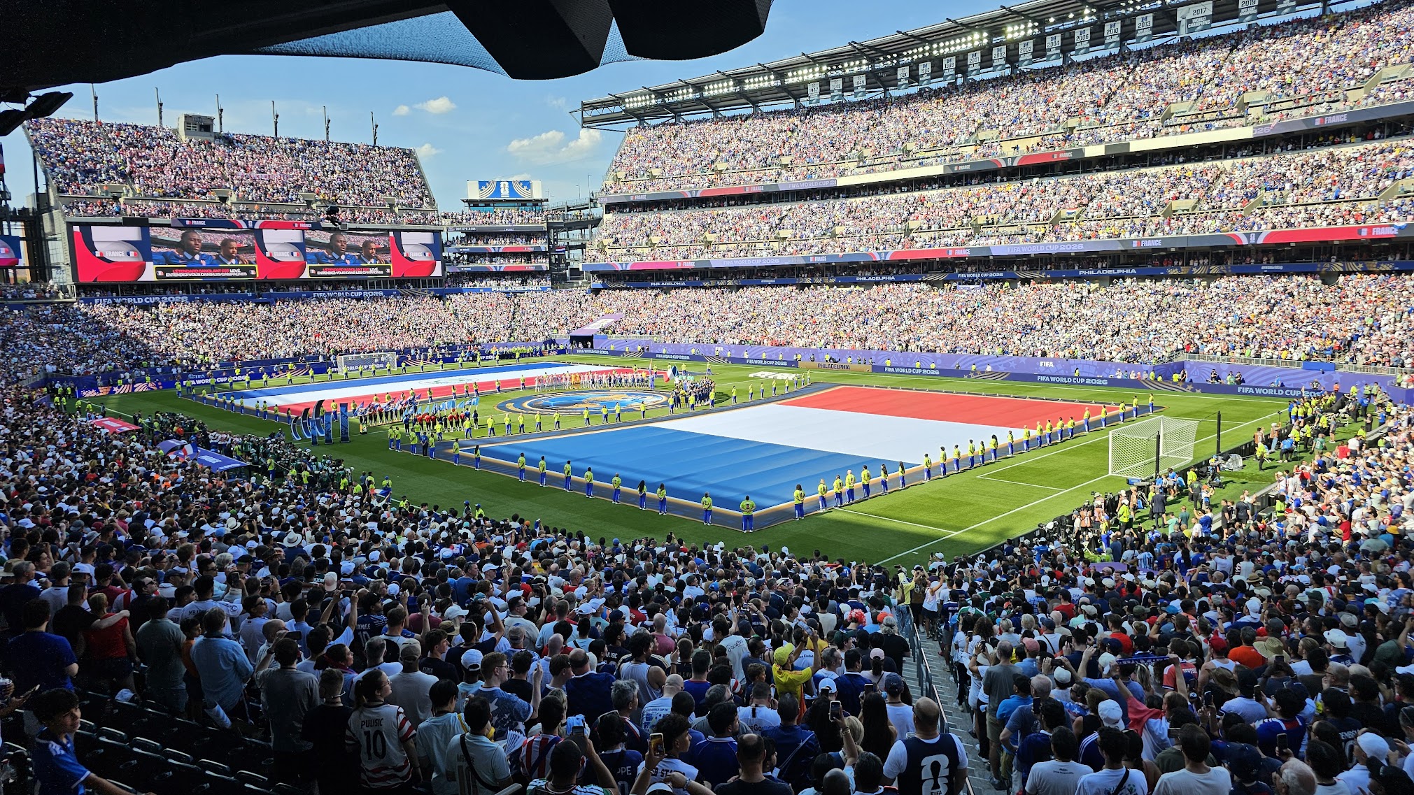 A giant French flag unfurled across the pitch at Lincoln Financial Field before the France vs. Paraguay Round of 16 match, stadium packed to capacity